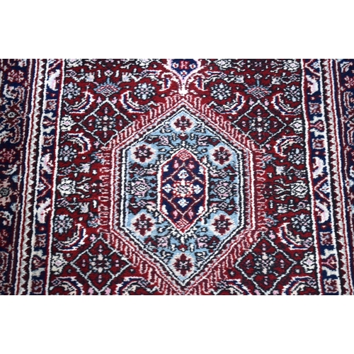 3169 - A Persian red ground runner 300 x 78cm.