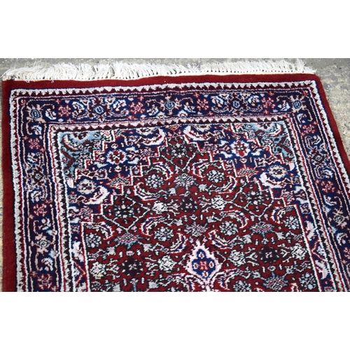 3169 - A Persian red ground runner 300 x 78cm.