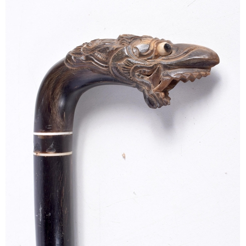 3338 - A carved Ebony and  horn handled  walking cane 85 cm