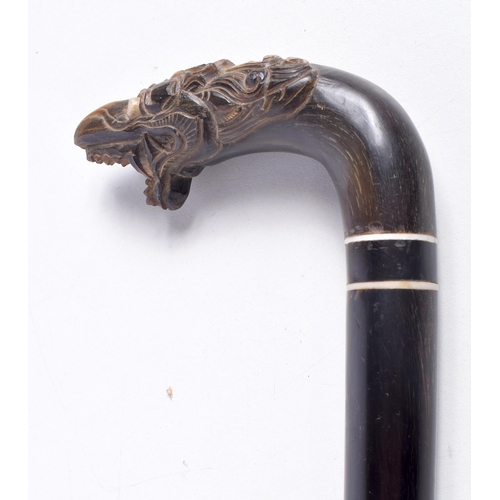 3338 - A carved Ebony and  horn handled  walking cane 85 cm