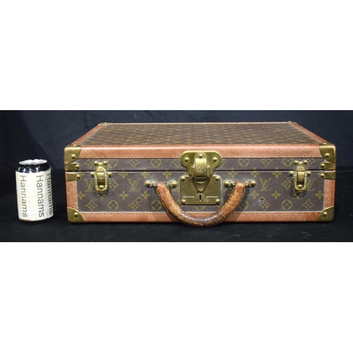 3754 - A Louis Vuitton suitcase with paper Label to the interior Serial number 872047, the central lock bea... 