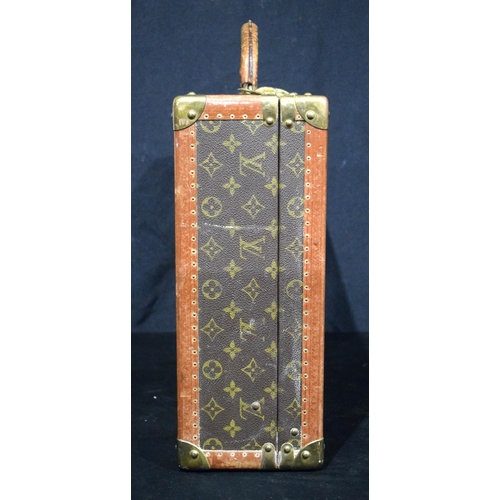 3754 - A Louis Vuitton suitcase with paper Label to the interior Serial number 872047, the central lock bea... 