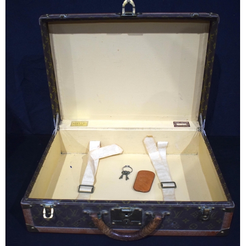 3754 - A Louis Vuitton suitcase with paper Label to the interior Serial number 872047, the central lock bea... 