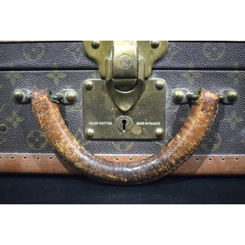 3754 - A Louis Vuitton suitcase with paper Label to the interior Serial number 872047, the central lock bea... 