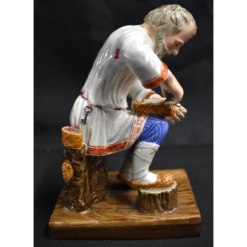 16 - A LATE 19TH CENTURY RUSSIA ST PETERSBURG PORCELAIN FIGURE OF A COBBLER modelled repairing a shoe. 14... 