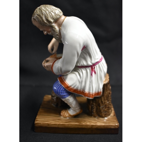 16 - A LATE 19TH CENTURY RUSSIA ST PETERSBURG PORCELAIN FIGURE OF A COBBLER modelled repairing a shoe. 14... 