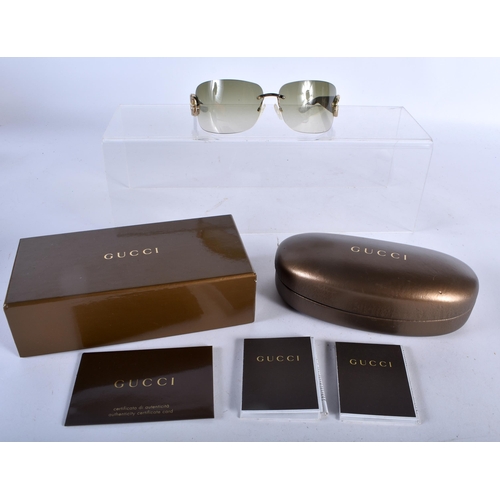 282 - A Boxed and Cased Pair of Gucci Ladies Sunglasses.  13.8cm wide