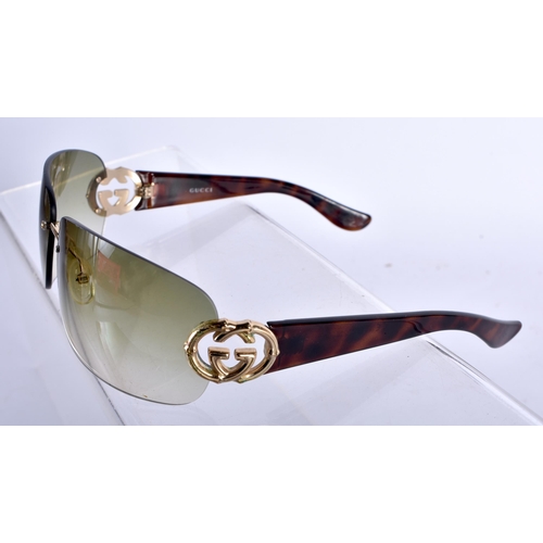 282 - A Boxed and Cased Pair of Gucci Ladies Sunglasses.  13.8cm wide