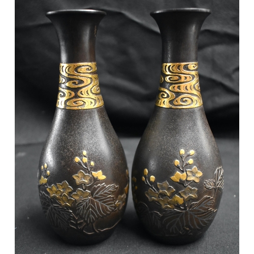 52 - A FINE PAIR OF 19TH CENTURY JAPANESE MEIJI PERIOD GOLD ONLAID IRON VASES decorated in relief with fo... 