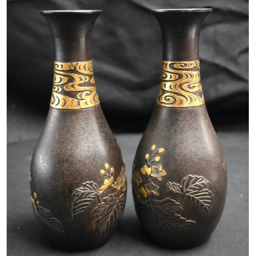 52 - A FINE PAIR OF 19TH CENTURY JAPANESE MEIJI PERIOD GOLD ONLAID IRON VASES decorated in relief with fo... 