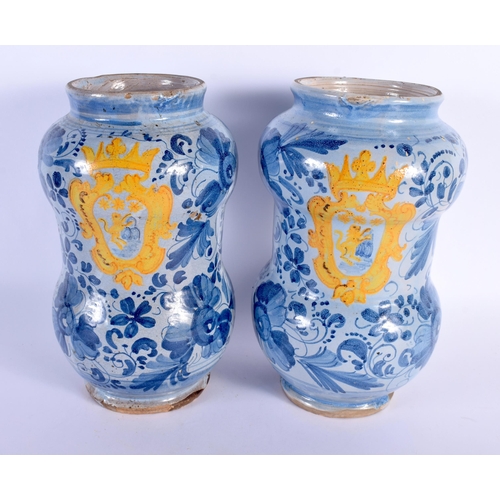 577 - A PAIR OF 18TH CENTURY ITALIAN FAIENCE ALBARELLO DRUG JARS painted with an armorial amongst flowers.... 