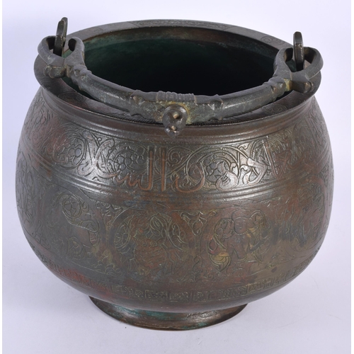 580 - A 15TH/16TH CENTURY MIDDLE EASTERN ISLAMIC BRONZE SWING HANDLED BUCKET engraved all over with animal... 