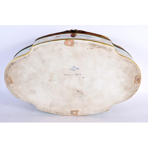 595 - A VERY LARGE EARLY 20TH CENTURY FRENCH SEVRES PORCELAIN OVAL LOBED CASKET painted with three figures... 