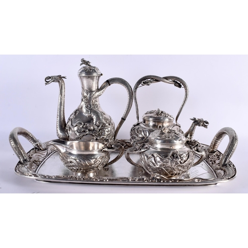 604 - A FINE 19TH CENTURY JAPANESE MEIJI PERIOD SILVER TEASET ON TRAY decorated in relief with powerful dr... 