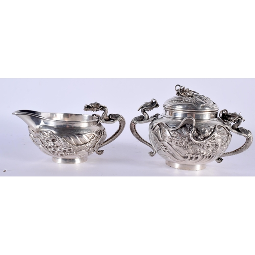 604 - A FINE 19TH CENTURY JAPANESE MEIJI PERIOD SILVER TEASET ON TRAY decorated in relief with powerful dr... 