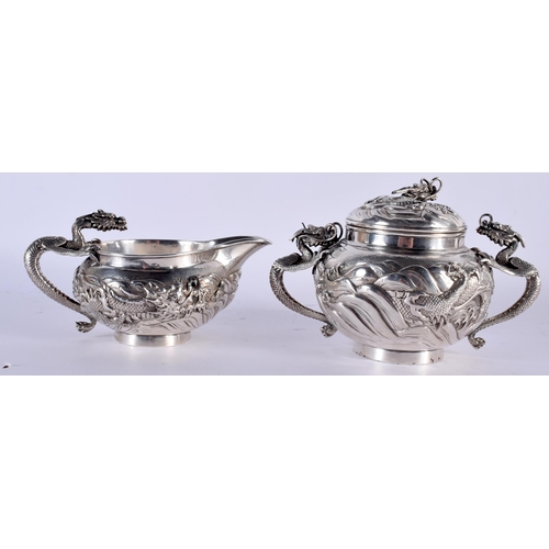 604 - A FINE 19TH CENTURY JAPANESE MEIJI PERIOD SILVER TEASET ON TRAY decorated in relief with powerful dr... 