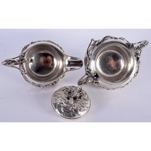 604 - A FINE 19TH CENTURY JAPANESE MEIJI PERIOD SILVER TEASET ON TRAY decorated in relief with powerful dr... 