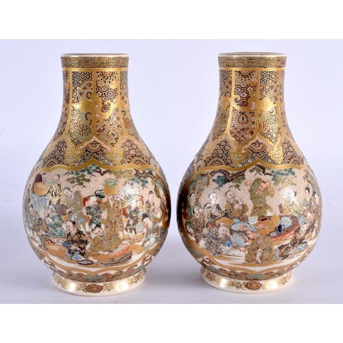 605 - A PAIR OF 19TH CENTURY JAPANESE MEIJI PERIOD SATSUMA VASES painted with figures, under an elaborate ... 