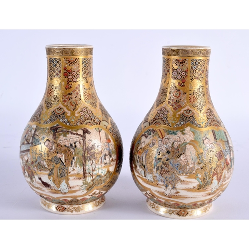 605 - A PAIR OF 19TH CENTURY JAPANESE MEIJI PERIOD SATSUMA VASES painted with figures, under an elaborate ... 