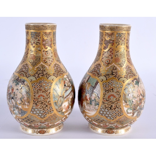 605 - A PAIR OF 19TH CENTURY JAPANESE MEIJI PERIOD SATSUMA VASES painted with figures, under an elaborate ... 