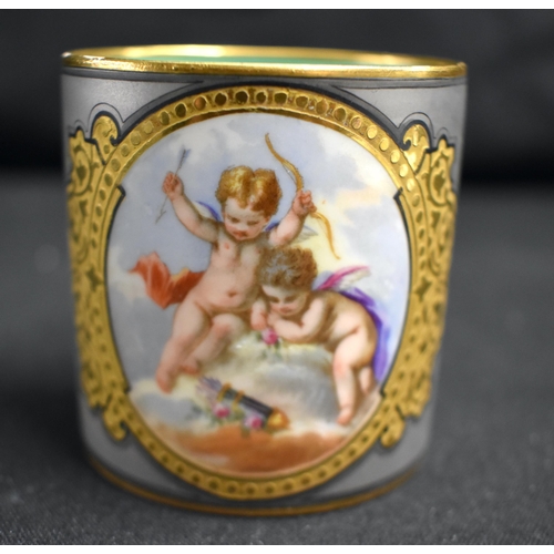 61 - AN UNUSUAL LATE 19TH CENTURY FRENCH SEVRES PORCELAIN TEACUP AND SAUCER painted with putti on an unus... 