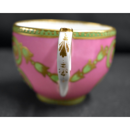 62 - AN 18TH CENTURY FRENCH SEVRES PORCELAIN TEACUP AND SAUCER painted with a brace of love birds within ... 