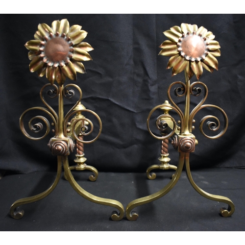 63 - A PAIR OF ARTS AND CRAFTS BRASS AND COPPER SUNFLOWER ANDIRONS of naturalistic form, with scrolling s... 