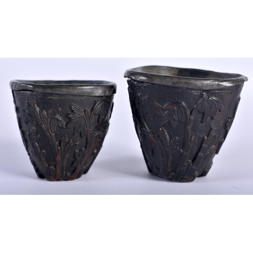 72 - A PAIR OF 17TH/18TH CENTURY CHINESE CARVED COCONUT SHELL CUPS Kangxi/Yongzheng, decorated with trees... 