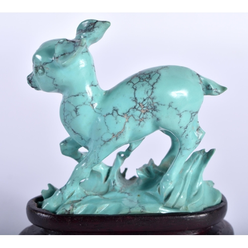 75 - A 19TH CENTURY CHINESE CARVED TURQUOISE FIGURE OF A ROAMING DEER Qing, modelled upon a naturalistic ... 