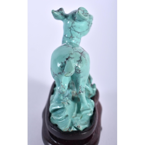 75 - A 19TH CENTURY CHINESE CARVED TURQUOISE FIGURE OF A ROAMING DEER Qing, modelled upon a naturalistic ... 