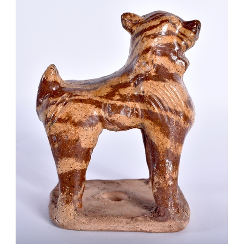 79 - AN EARLY CHINESE MARBLEISED POTTERY BEAST modelled standing upon an unglazed base. 11 cm x 8 cm.