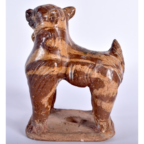 79 - AN EARLY CHINESE MARBLEISED POTTERY BEAST modelled standing upon an unglazed base. 11 cm x 8 cm.