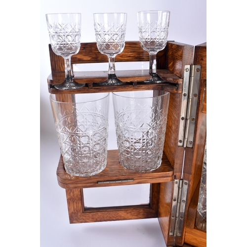 100C - A GENTLEMANS DRINKING COMPENDIUM, consisting of three decanters, four glasses, and three sherry glas... 