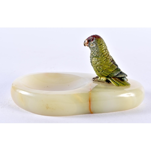 100D - AN AUSTRIAN COLD PAINTED BRONZE PARROT, sat upon a hardstone ashtray. 11cm x 7.5cm