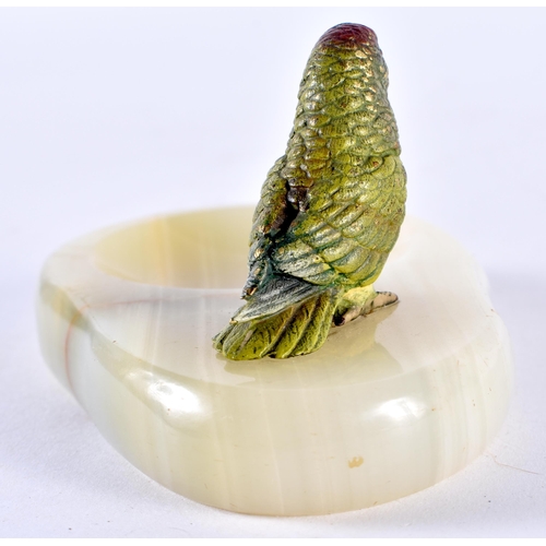 100D - AN AUSTRIAN COLD PAINTED BRONZE PARROT, sat upon a hardstone ashtray. 11cm x 7.5cm