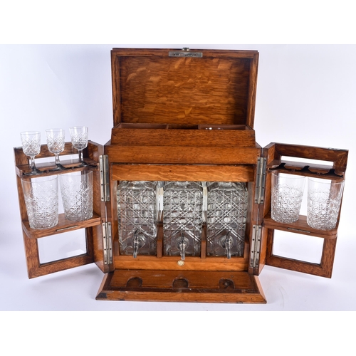 100C - A GENTLEMANS DRINKING COMPENDIUM, consisting of three decanters, four glasses, and three sherry glas... 