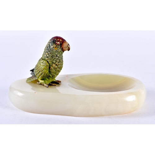 100D - AN AUSTRIAN COLD PAINTED BRONZE PARROT, sat upon a hardstone ashtray. 11cm x 7.5cm