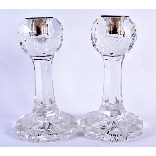 106 - AN UNUSUAL PAIR OF ANTIQUE CUT GLASS FACETTED CANDLESTICKS. 20 cm high.