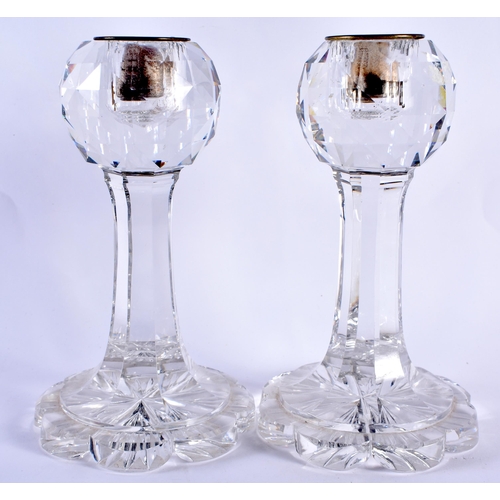 106 - AN UNUSUAL PAIR OF ANTIQUE CUT GLASS FACETTED CANDLESTICKS. 20 cm high.