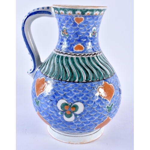 123 - A TURKISH OTTOMAN IZNIK POTTERY WATER JUG painted with motifs. 21 cm x 13 cm.