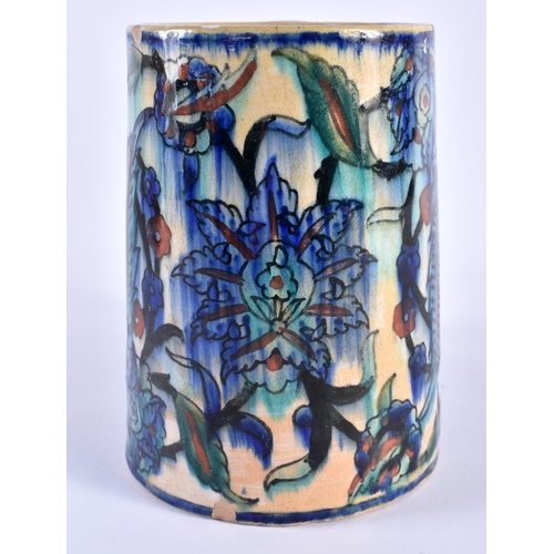 125 - A MIDDLE EASTERN IZNIK FAIENCE POTTERY TANKARD painted with floral sprays. 16 cm x 14 cm.