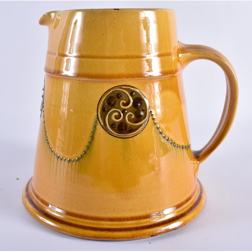 140 - A RARE LARGE ARTS AND CRAFTS LIBERTY & CO YELLOW GLAZED JUG decorated with circular swirling motifs ... 