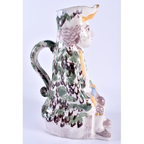 147 - AN 18TH/19TH CENTURY FRENCH FAIENCE TIN GLAZED JUG modelled as a seated male. 24 cm x 10 cm.