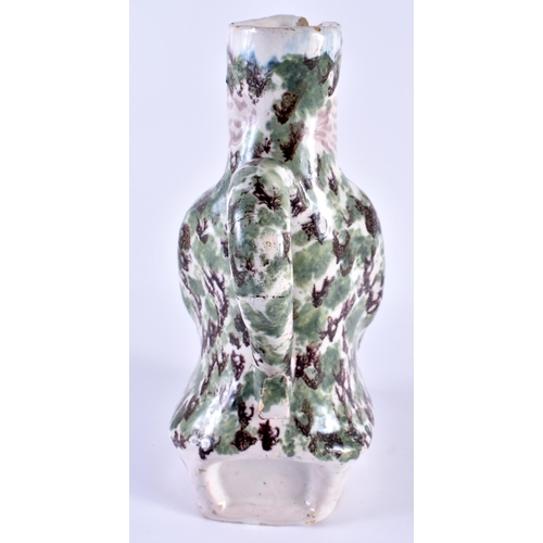 147 - AN 18TH/19TH CENTURY FRENCH FAIENCE TIN GLAZED JUG modelled as a seated male. 24 cm x 10 cm.