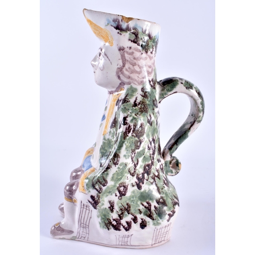 147 - AN 18TH/19TH CENTURY FRENCH FAIENCE TIN GLAZED JUG modelled as a seated male. 24 cm x 10 cm.