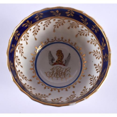 22 - AN OVERSIZED 18TH CENTURY WORCESTER FLUTED ARMORIAL TEABOWL AND SAUCER painted with a central crest ... 