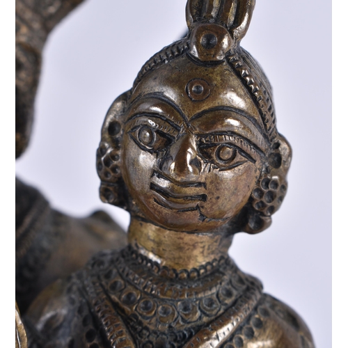 319 - A 19TH CENTURY INDIAN BRONZE FIGURE OF A HINDU DEITY modelled with an attendant. 17 cm x 10 cm.