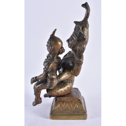 319 - A 19TH CENTURY INDIAN BRONZE FIGURE OF A HINDU DEITY modelled with an attendant. 17 cm x 10 cm.