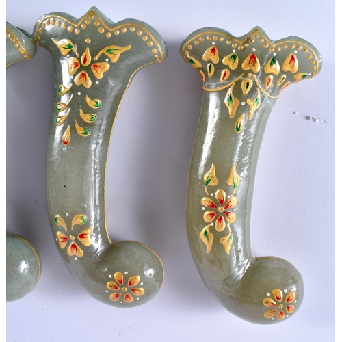 321 - A SET OF FIVE MIDDLE EASTERN QAJAR LACQUER HARDSTONE DAGGER HANDLES overlaid with foliage and vines.... 