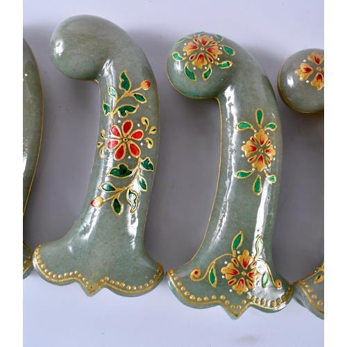 321 - A SET OF FIVE MIDDLE EASTERN QAJAR LACQUER HARDSTONE DAGGER HANDLES overlaid with foliage and vines.... 